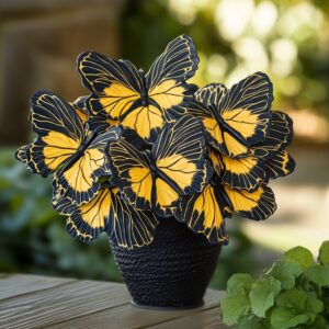 A vibrant arrangement of Begonia 'Moonlight Butterfly' with striking yellow and black butterfly-shaped leaves in a decorative pot