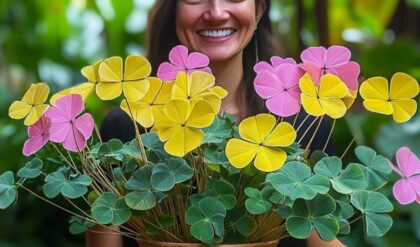 A woman smiling while holding a pot of colorful Butterfly Plant (Oxalis triangularis) with pink and yellow flowers.